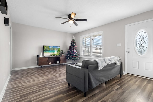 living room with ceiling fan and dark wood-type flooring