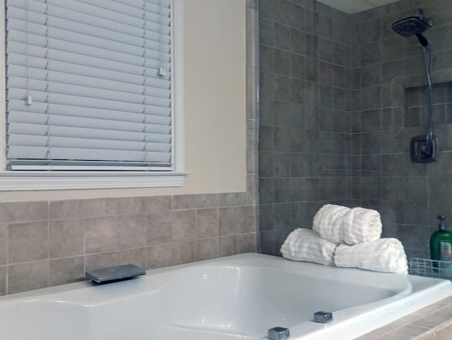 bathroom featuring a relaxing tiled tub