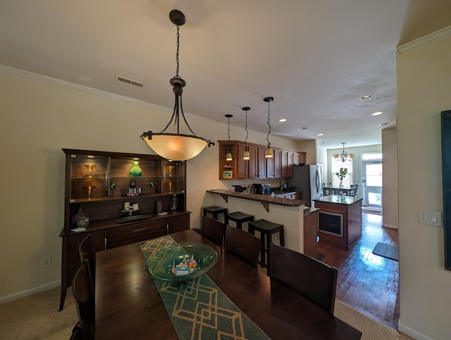 dining room with an inviting chandelier and crown molding