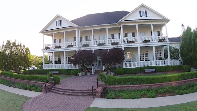 view of front facade featuring covered porch and a balcony