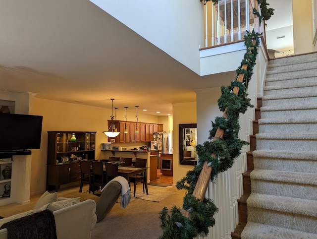 stairway featuring crown molding