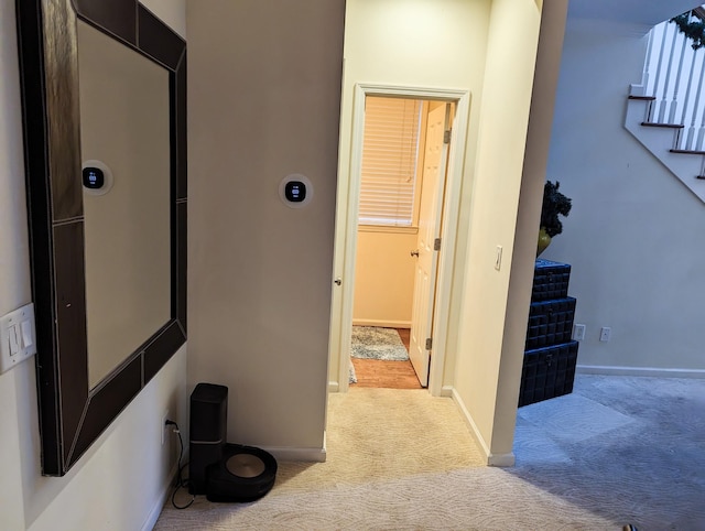 hallway with light colored carpet