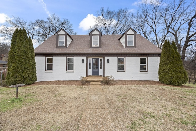 new england style home featuring a front yard