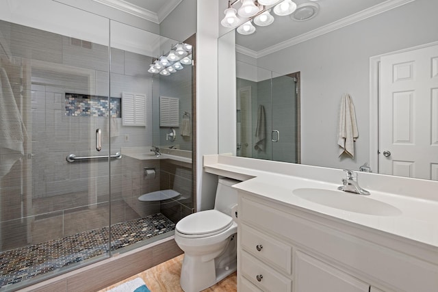 bathroom featuring ornamental molding, vanity, toilet, and a shower with shower door