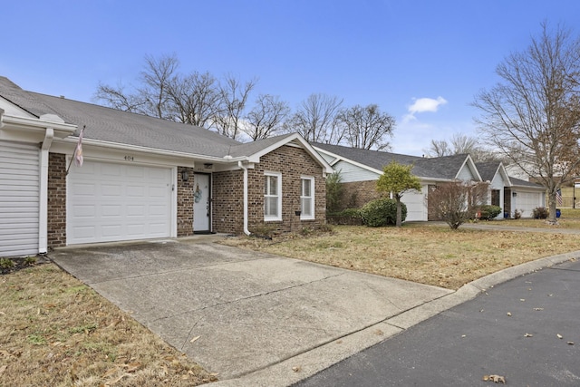 ranch-style home with a front yard and a garage