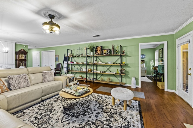 living room featuring dark hardwood / wood-style floors, a textured ceiling, and ornamental molding