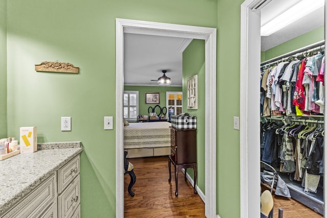 bathroom with vanity, hardwood / wood-style flooring, ceiling fan, and crown molding