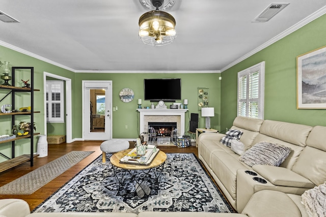 living room featuring hardwood / wood-style flooring and crown molding