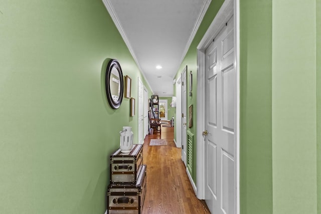 hall featuring hardwood / wood-style floors and crown molding