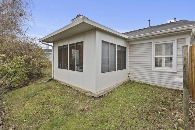 view of home's exterior with a yard