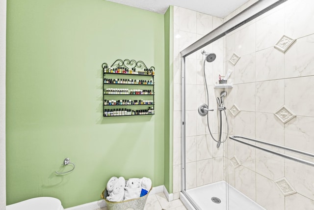 bathroom featuring tile patterned floors, an enclosed shower, and toilet