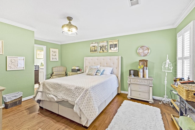 bedroom featuring hardwood / wood-style floors and crown molding