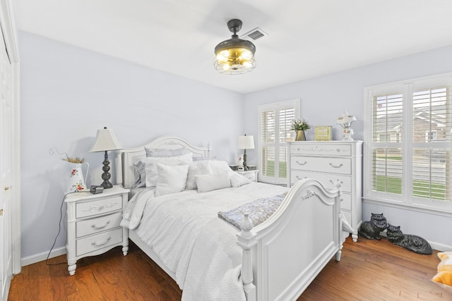 bedroom featuring hardwood / wood-style floors and multiple windows