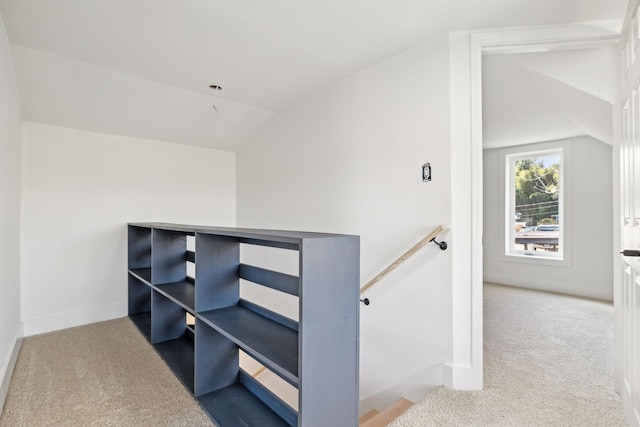 staircase with lofted ceiling and carpet flooring