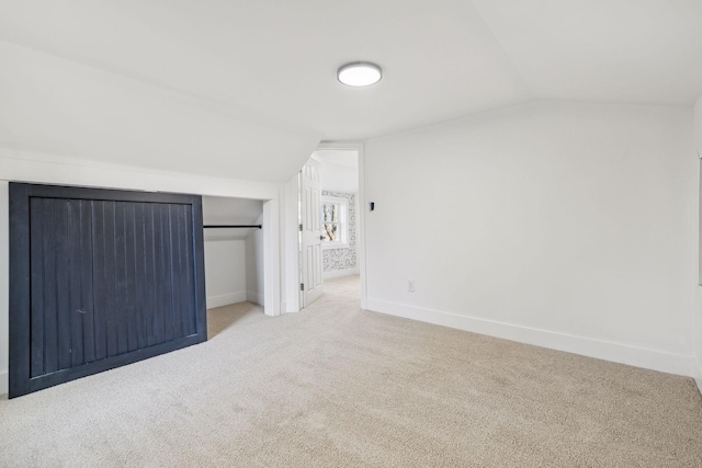 additional living space with lofted ceiling and carpet flooring