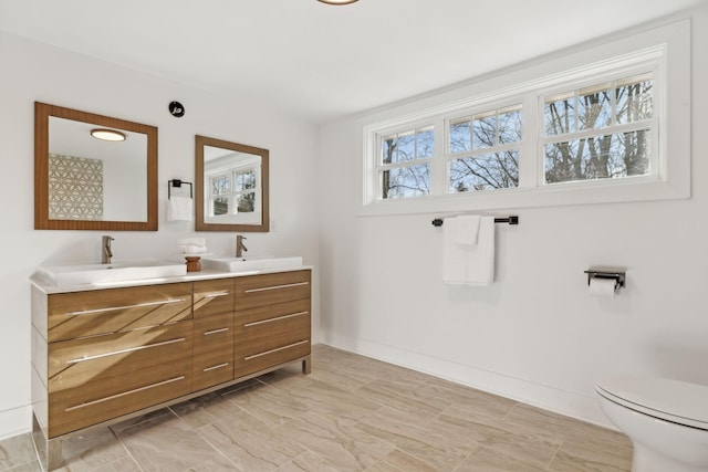 bathroom featuring vanity and toilet