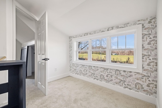 interior space with vaulted ceiling and a healthy amount of sunlight