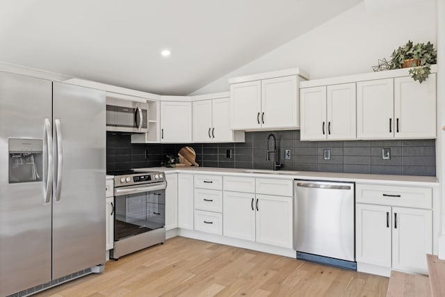 kitchen featuring stainless steel appliances, white cabinets, and sink