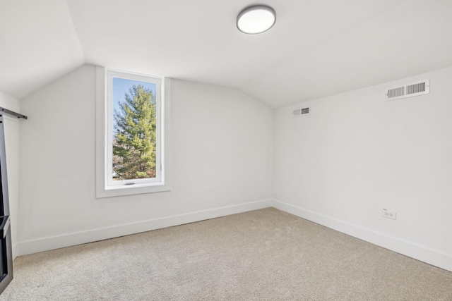 bonus room featuring carpet floors and vaulted ceiling