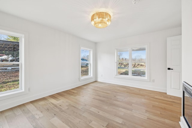 empty room with a healthy amount of sunlight and light wood-type flooring