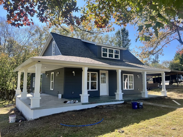 view of front facade featuring covered porch and a front yard