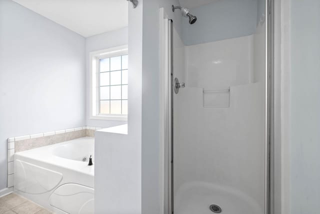 bathroom with tile patterned flooring and independent shower and bath