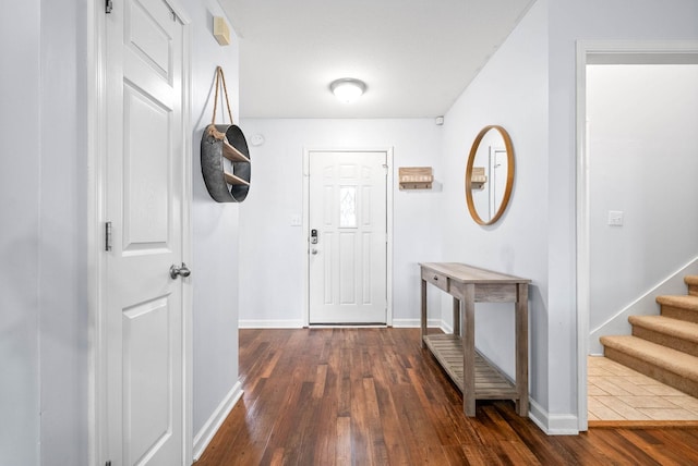 entryway with dark hardwood / wood-style flooring