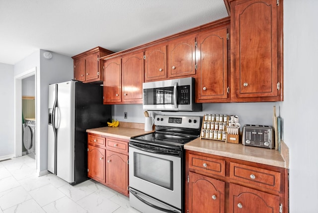 kitchen with washer / dryer and stainless steel appliances