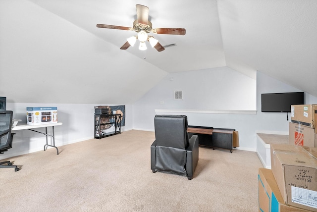 carpeted office space with ceiling fan and vaulted ceiling