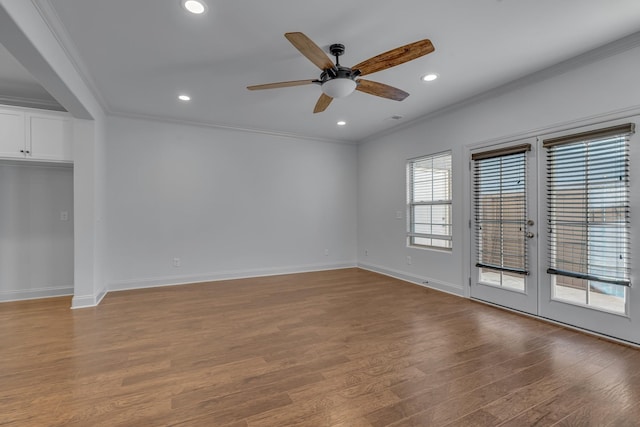 empty room featuring ceiling fan, light wood-type flooring, and ornamental molding