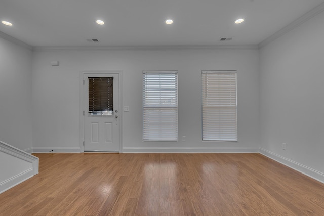 unfurnished room featuring light wood-type flooring and ornamental molding