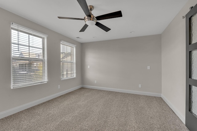 empty room featuring carpet floors and ceiling fan