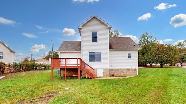 rear view of property featuring a lawn and a deck