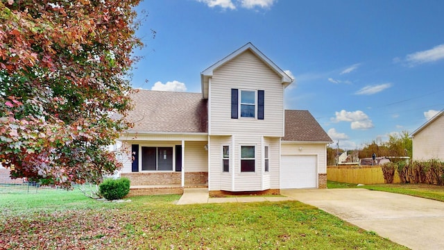 view of property with a front lawn and a garage