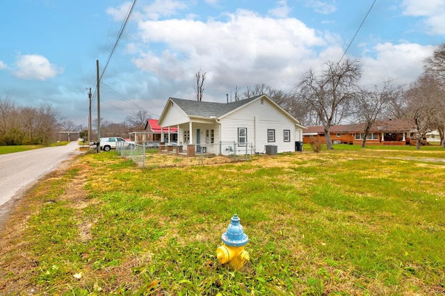 back of property featuring a porch and a yard