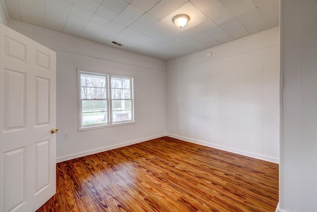 empty room with hardwood / wood-style floors