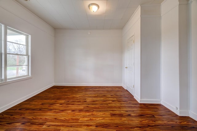 empty room featuring dark hardwood / wood-style floors and a healthy amount of sunlight