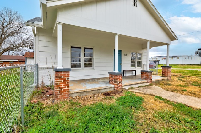 back of property with covered porch