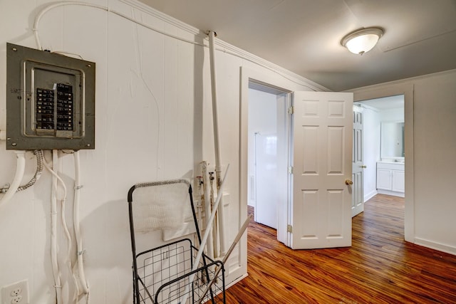 corridor with hardwood / wood-style floors and electric panel