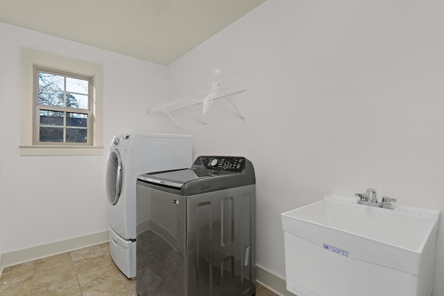 washroom featuring washer and clothes dryer and sink