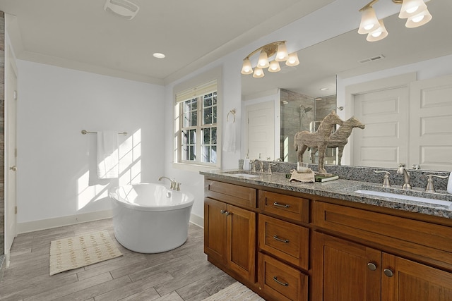 bathroom with plus walk in shower, vanity, and a notable chandelier