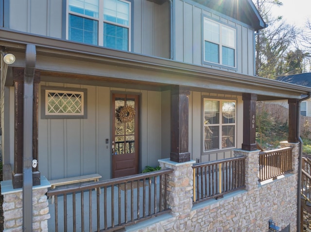 view of exterior entry featuring covered porch