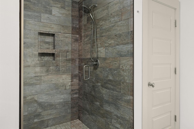 bathroom featuring a shower with shower door