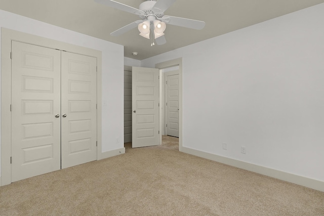 unfurnished bedroom with a closet, ceiling fan, and light colored carpet