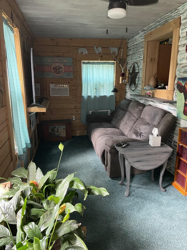 interior space with carpet, plenty of natural light, and wood walls