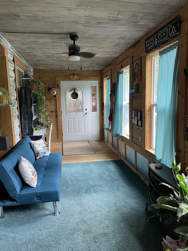 unfurnished sunroom with ceiling fan