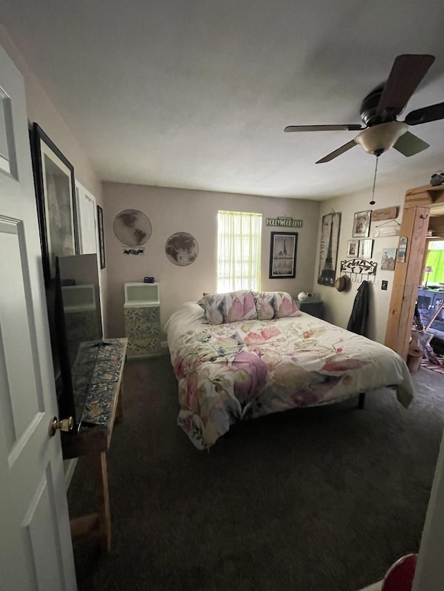 bedroom featuring a ceiling fan and dark colored carpet