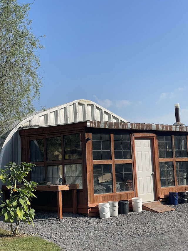 view of outbuilding with a sunroom