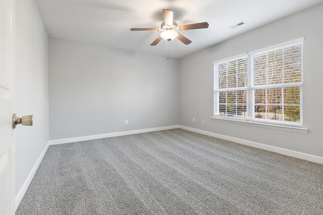 carpeted empty room featuring ceiling fan