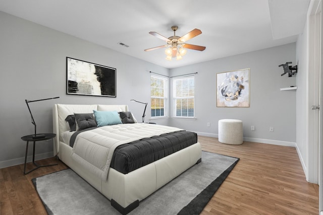 bedroom with ceiling fan and wood-type flooring